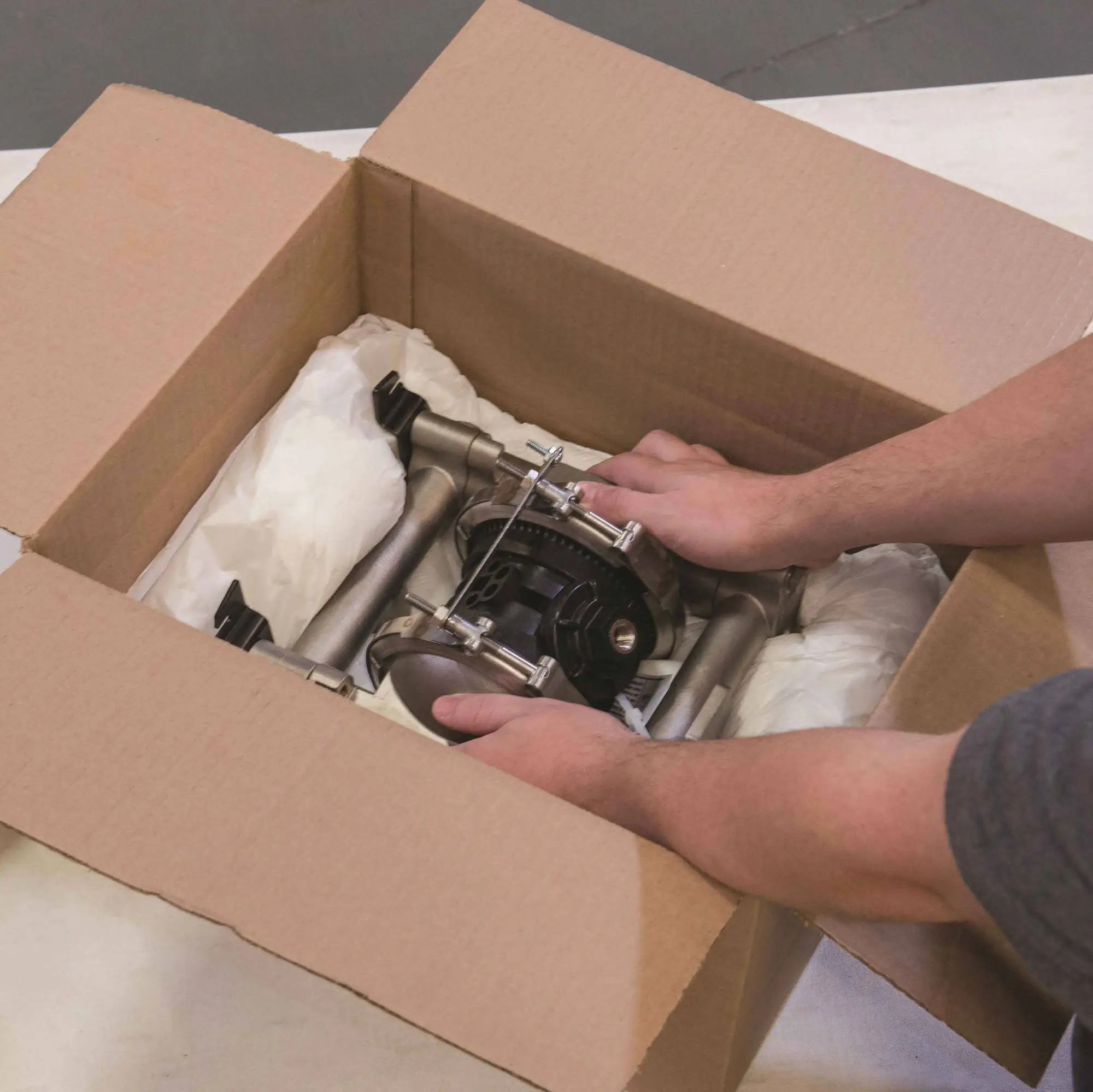 A precisely packaged auto part inside a box with protective foam.